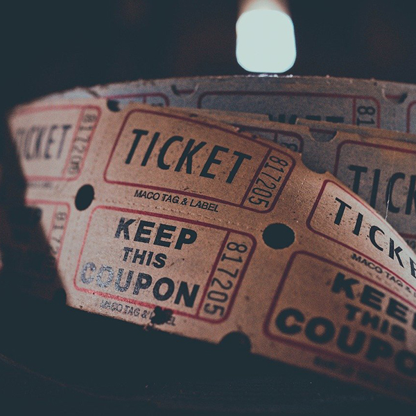 A roll of tickets on a table, symbolizing the development of e-commerce for event ticketing services.