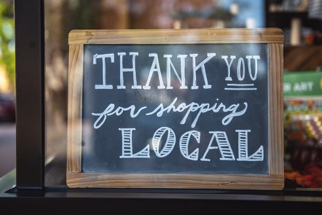 sign in shop window saying Thank You For Shopping Local