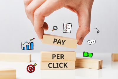 persons hands placin blocks ontyop of one another with the words pay per click