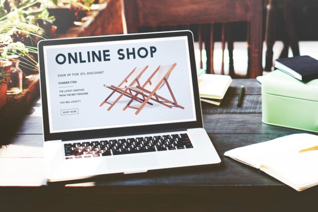 laptop on table with a e-commerce shop webpage